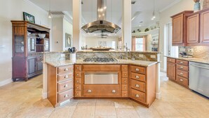 A spacious kitchen with a central island, stainless steel appliances, and wooden cabinetry. - Waterfront Arcadia Home w/ Dock on Peace River (Fort Ogden)