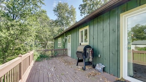 A wooden deck with a grill and a bag of charcoal. - Ozark Getaway Near Roaring River & Fishing (Cassville)