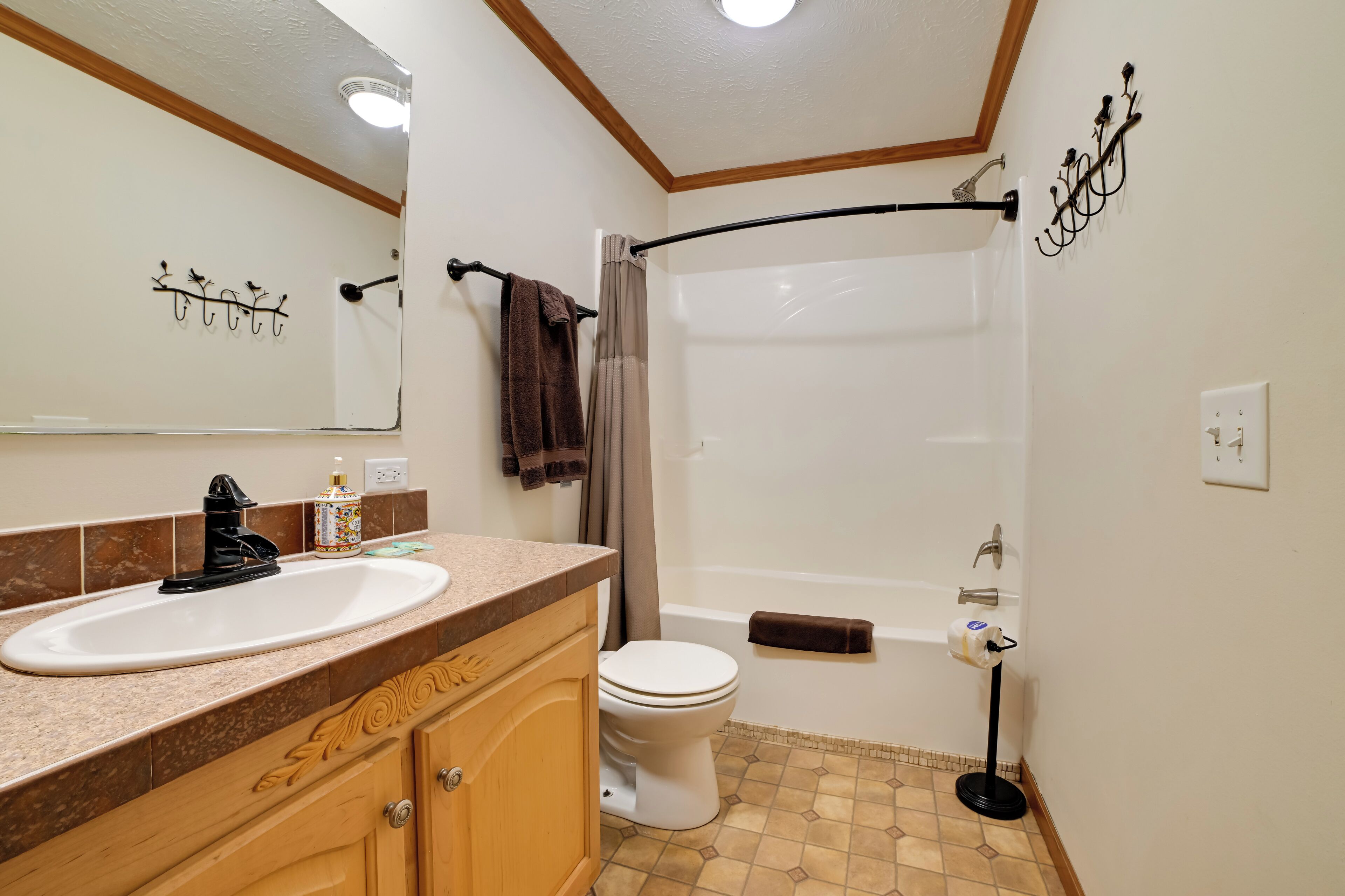 A bathroom with a sink, toilet, and bathtub.