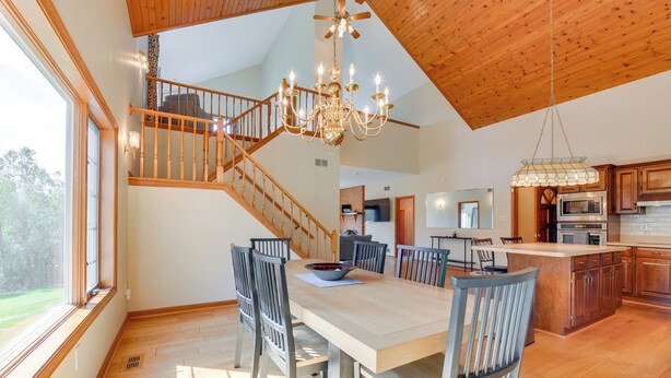 A spacious dining area with a wooden staircase, a chandelier, and a view of the outdoors. - 3 Mi to Prettyboy Reservoir! Maryland Hideaway (Freeland)
