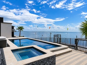 A swimming pool with a view of the sea and sky.