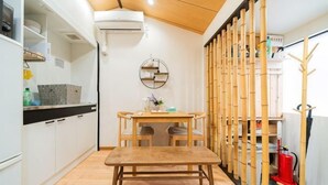 A compact kitchen with a dining table, chairs, and a wooden bench. - new opened! 4 minutes from Shijo Omiya station, best value bungalow, shower toilet separate (Kyoto)