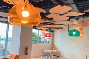 A modern interior with hanging pendant lights, a staircase, and a dining area. - Aveline Suites II, Garden/City view,2br, amenities (Mandaluyong)