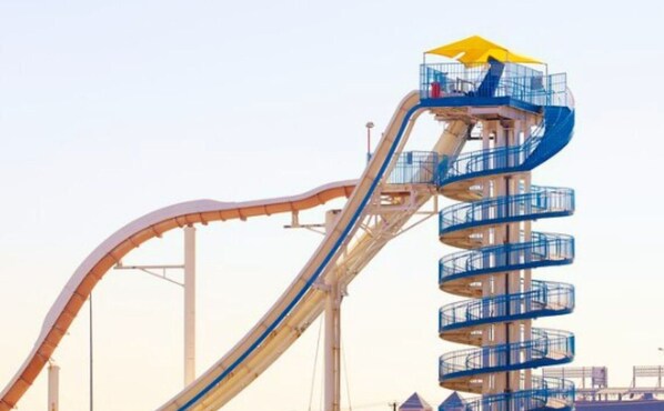 A water slide with a spiral descent and a viewing platform at the top. - 5BR w/ Backyard Paradise, Pool, Cinema, Games (North Richland Hills)