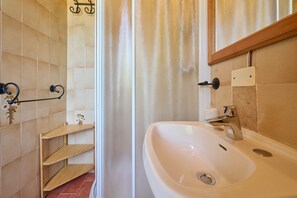 A bathroom with a white sink, a mirror, and a shower curtain. - Room 'Santa Lorica - Camera 12' with Shared Pool, Shared Garden and Wi-Fi (Sassetta)