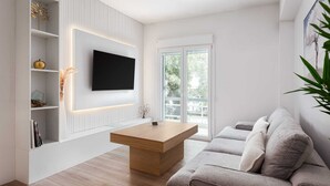 Un salon moderne avec un téléviseur à écran plat fixé à un mur blanc, une table basse en bois, un canapé gris et une porte en verre donnant sur un espace extérieur.
