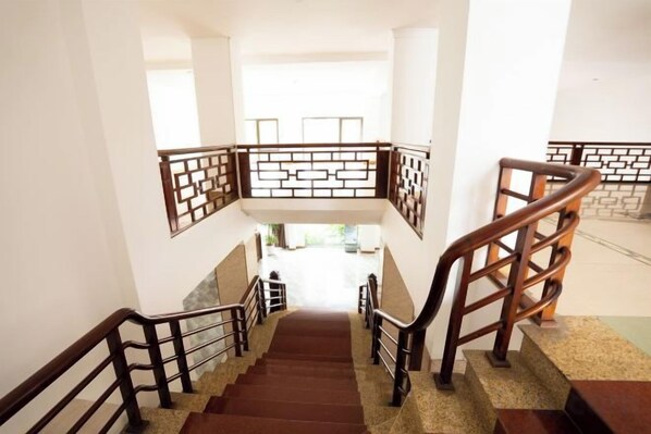 A staircase with wooden railings and a view of the interior space below. - Kim Thanh Hotel, Vinh Phuc - Near Heron Lake Golf, DAM Vac (Dong Da)