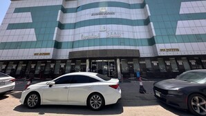 A multi-story building with a modern design, featuring a prominent entrance and signage indicating it is a serviced apartment complex. - Rafa Serviced Apartments - Economic (Riyadh)