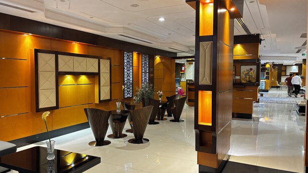 A modern hotel lobby with a polished floor, wooden paneling, and contemporary furniture. - Rafa Serviced Apartments - Economic (Riyadh)