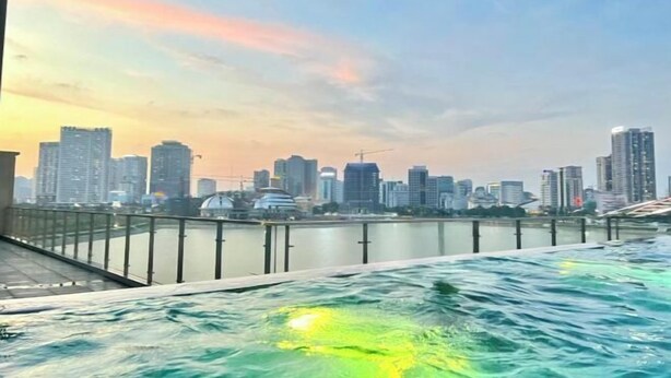 A waterfront view with a city skyline in the background. - Nanahousing-Nice Apartment near Korea Town & Chinese Area (Hanoi)