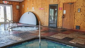 An indoor pool with a wooden wall, a hot tub, and a no-jumping sign. - Mountain Top View in Gatlinburg (Gatlinburg)