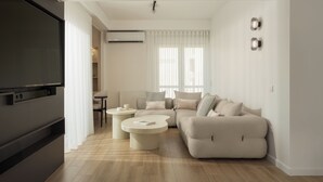 Una sala de estar moderna con sofá, mesa de centro y televisor.