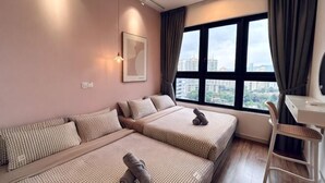 A modern hotel room with two beds, a desk, and a large window with a city view. - M Vertica Tower A Tower A by FEEL HOME (Kuala Lumpur)