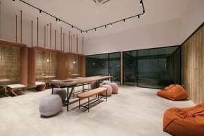 A modern interior with a dining area, seating, and a large glass wall. - M Vertica Tower A Tower A by FEEL HOME (Kuala Lumpur)