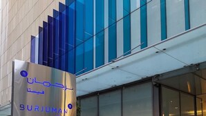 A modern building with a glass facade and a sign for "BURJUMAN VISTA". - Cozy 1BR Apartment Nr World Trade Centre (Dubai)