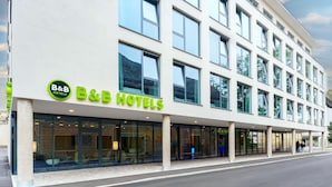 A B&B hotel with a modern facade, large windows, and a visible entrance.