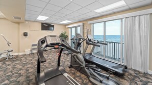 A fitness room with treadmills, an elliptical, and a stationary bike. - Island Royale 403 by Liquid Life (Gulf Shores)