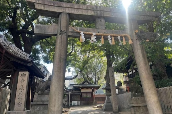 A traditional Japanese torii gate with a wooden walkway leading to a shrine.