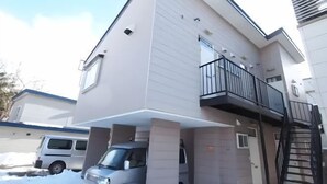 A modern multi-story residential building with a balcony on the second floor. - City Yugawa Room D (Hakodate)