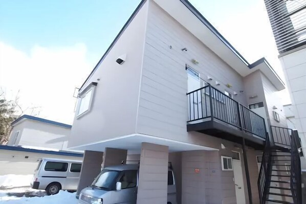 A modern multi-story residential building with a balcony on the second floor. - City Yugawa Room D (Hakodate)