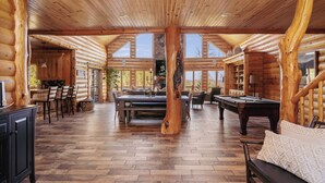 A spacious log cabin interior with a wooden dining table, a pool table, and a cozy seating area. - NorthLong Lake/Hot Tub, Sandy Beach (Brainerd)