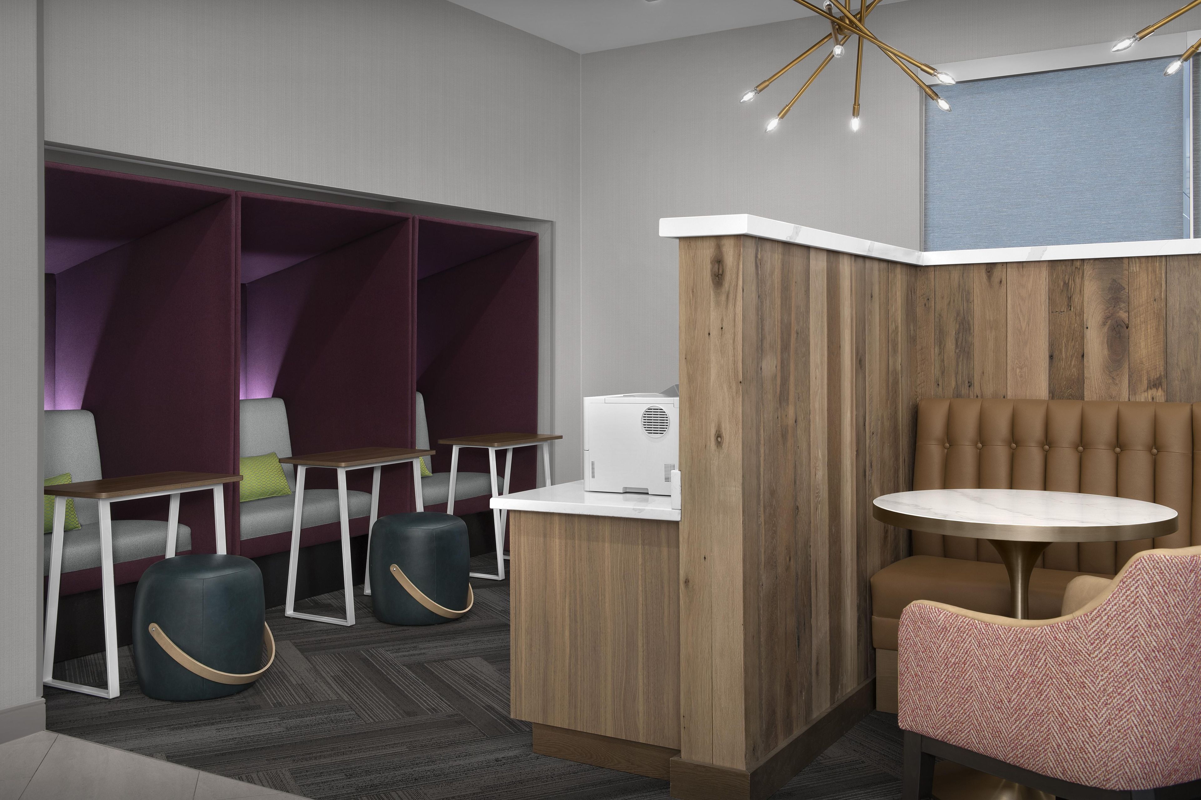 A modern interior with a seating area, a small table, and a wall-mounted heater.