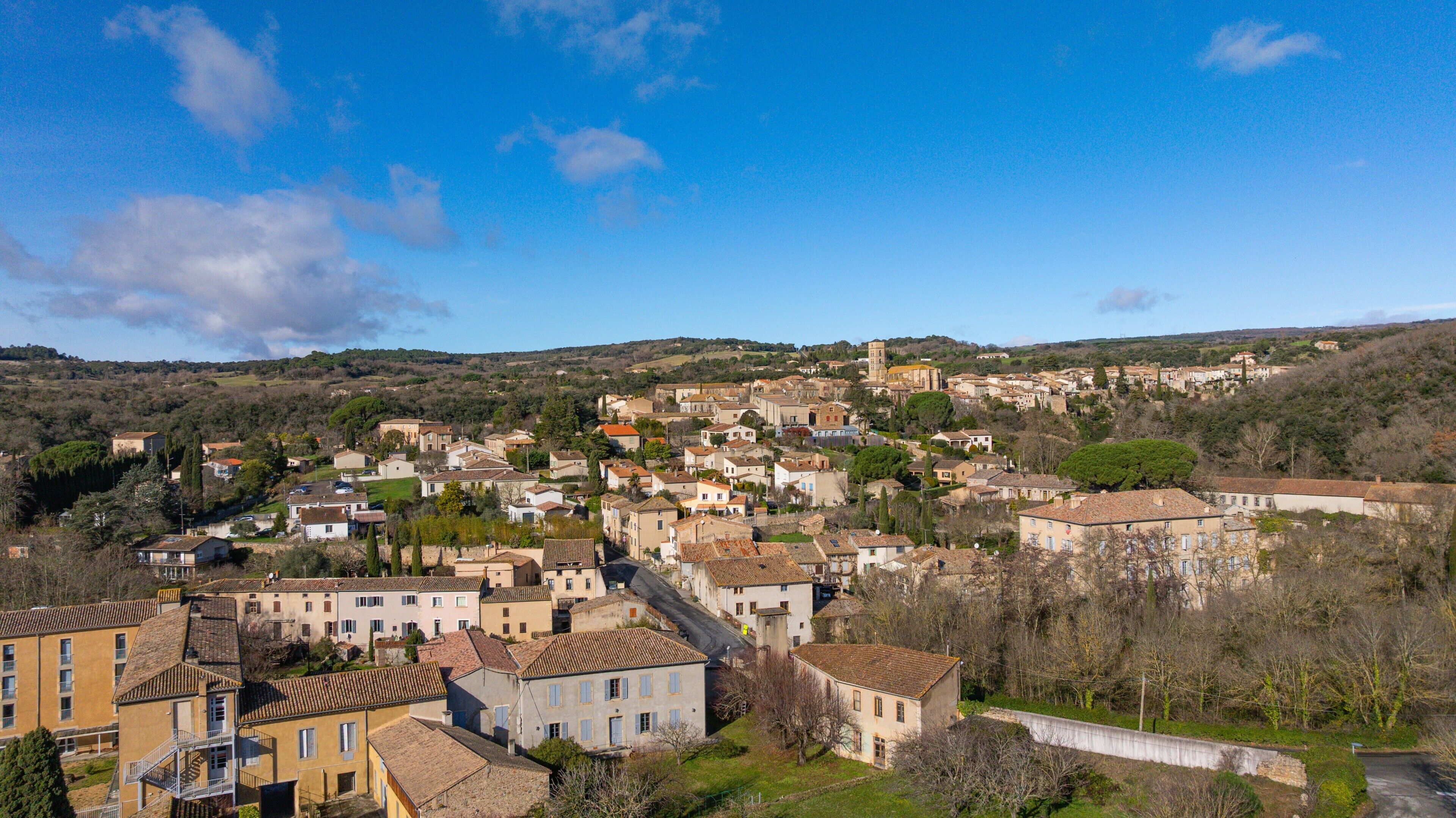 A hillside town with traditional architecture, a prominent church, and a mix of residential and commercial buildings.