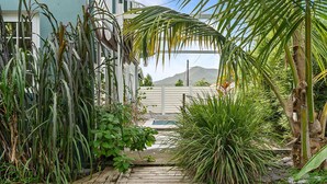 A wooden deck leading to a house surrounded by lush tropical plants. - Villa Mandarine - Two Bedroom Villa, Sleeps 4 (Le Diamant)