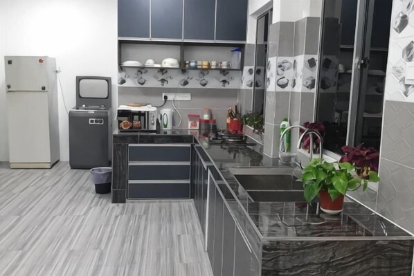 A modern kitchen with grey cabinets, a marble countertop, and a sink. - Cameron Farm House (Ulu Telom)