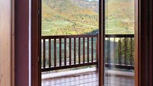 Ein Balkon mit Blick auf eine gebirgige Landschaft.