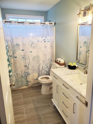 Shower, hair dryer, towels, toilet paper