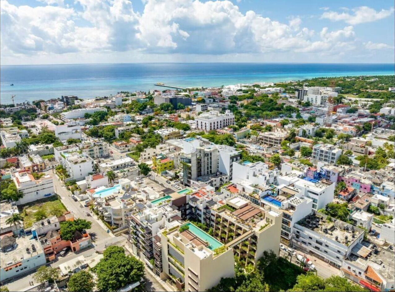 An aerial view of a densely built urban area with various buildings, including residential and commercial structures.