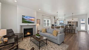 A spacious living room with a fireplace, a sofa, and a coffee table.
