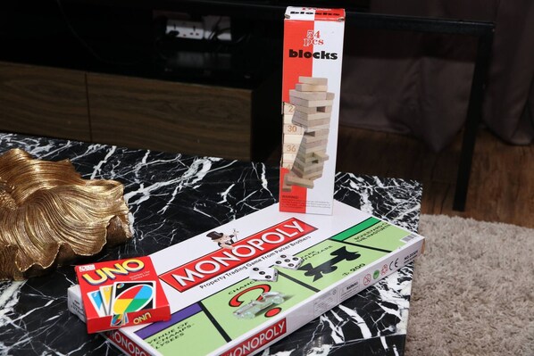 A Monopoly game box with a marble table and a golden decorative item. - Urbano Luxury Homestay at Maritime (George Town)