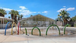 A water feature with colorful arches and a glass building in the background. - Lovely 2-bedroom condo with pools and AC in amazing St. George (St. George)