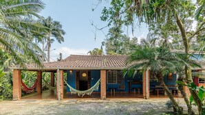 A house with a tiled roof, brick walls, and a covered porch with a hammock. - House With Pool and Barbecue in Itamambuca Cpi0130 (Ubatuba)