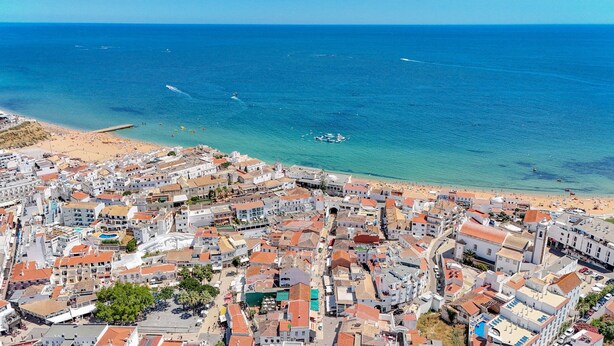 An aerial view of a coastal town with a beach, buildings, and boats. - Old Town Studio G 150m Praia T nel (Albufeira)