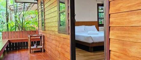 A wooden room with a bed and a bench.