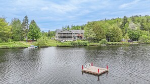 A lakeside property with a multi-story building, dock, and surrounding greenery. - Kamouraska, Lac et nature (Mont-Carmel)