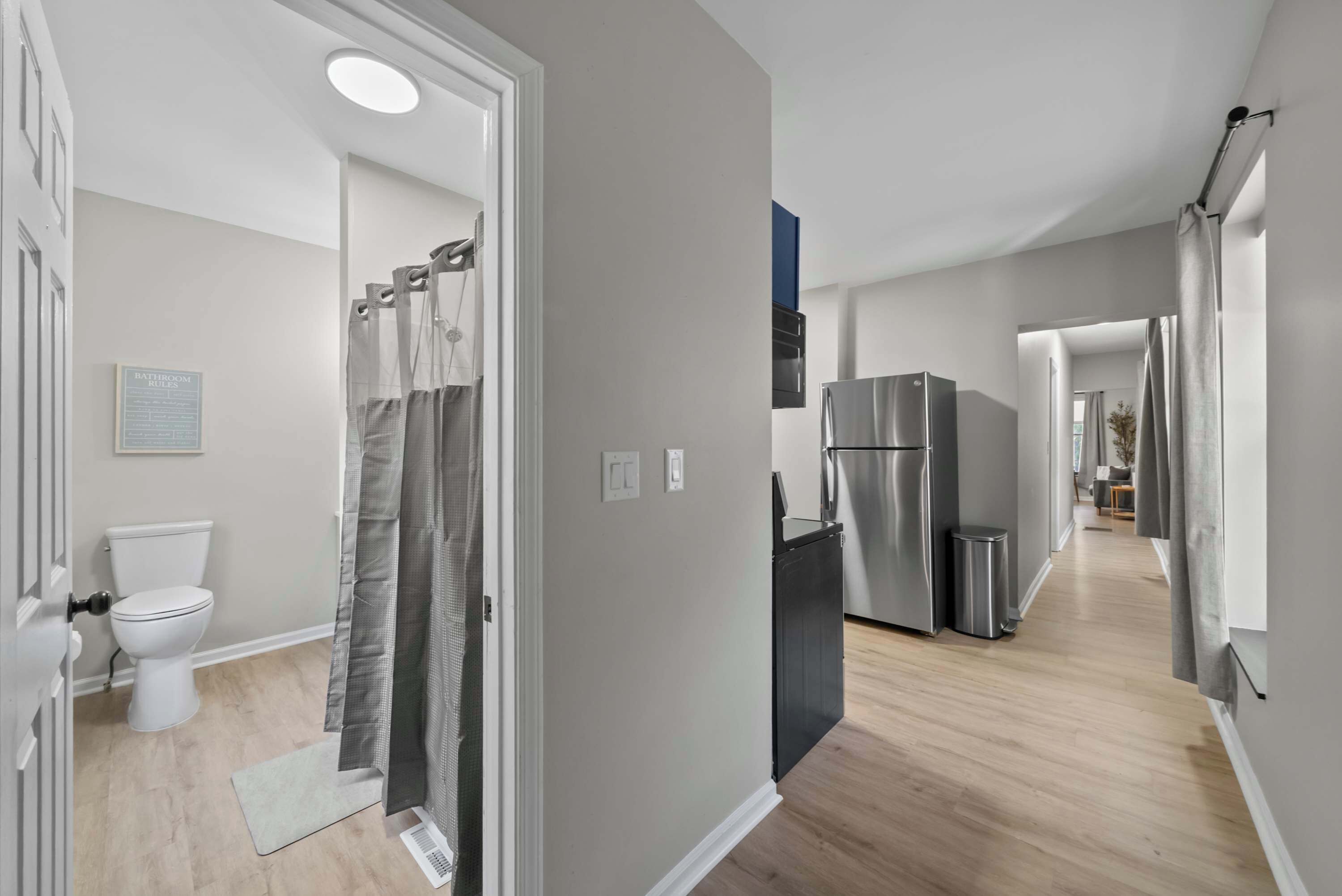 A modern kitchen with a stainless steel refrigerator, a sink, and a countertop.
