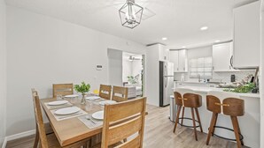 A modern kitchen with white cabinets, a built-in oven, and a stainless steel refrigerator. - 4BR Oasis | Jacuzzi/Gym & Game room | Sleeps 12! (Tampa)