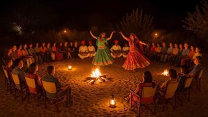 A group of people seated in a circle around a campfire at night. - Desert Island Camp & Resort Jaisalmer (Jaisalmer)