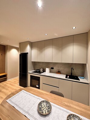 Deluxe Apartment | Private kitchen | Fridge