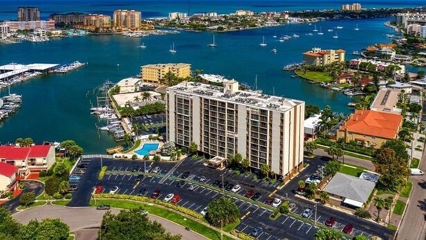 A high-rise hotel with a marina in the background. - Wonderful fully furnished 2-bedroom condo in Clearwater Beach. (Clearwater Beach)