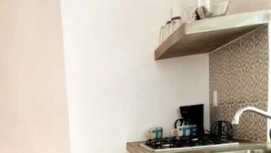 A kitchen with a gas stove, a sink, and a patterned backsplash. - 101 Apartment Luna Vallarta 4P (Puerto Vallarta)