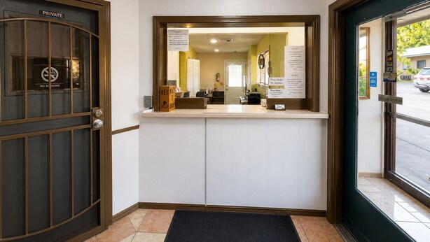 A reception area with a private entrance, a reception desk, and a view of the street outside.