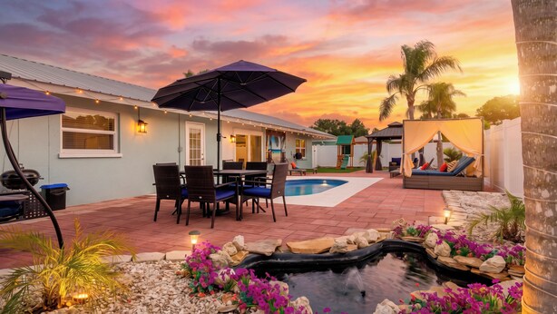 A patio with a pool, outdoor seating, and a small water feature. - Family home with private heated pool and patio, near Anna Maria Island & IMG. (Bradenton)
