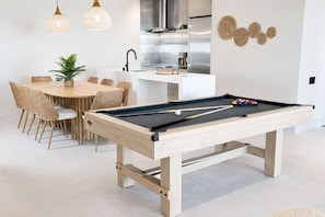 A modern living space with a pool table, dining area, and kitchen. - A+ Location • Hot Tub & Strip Views • Gym & Pool (Las Vegas)