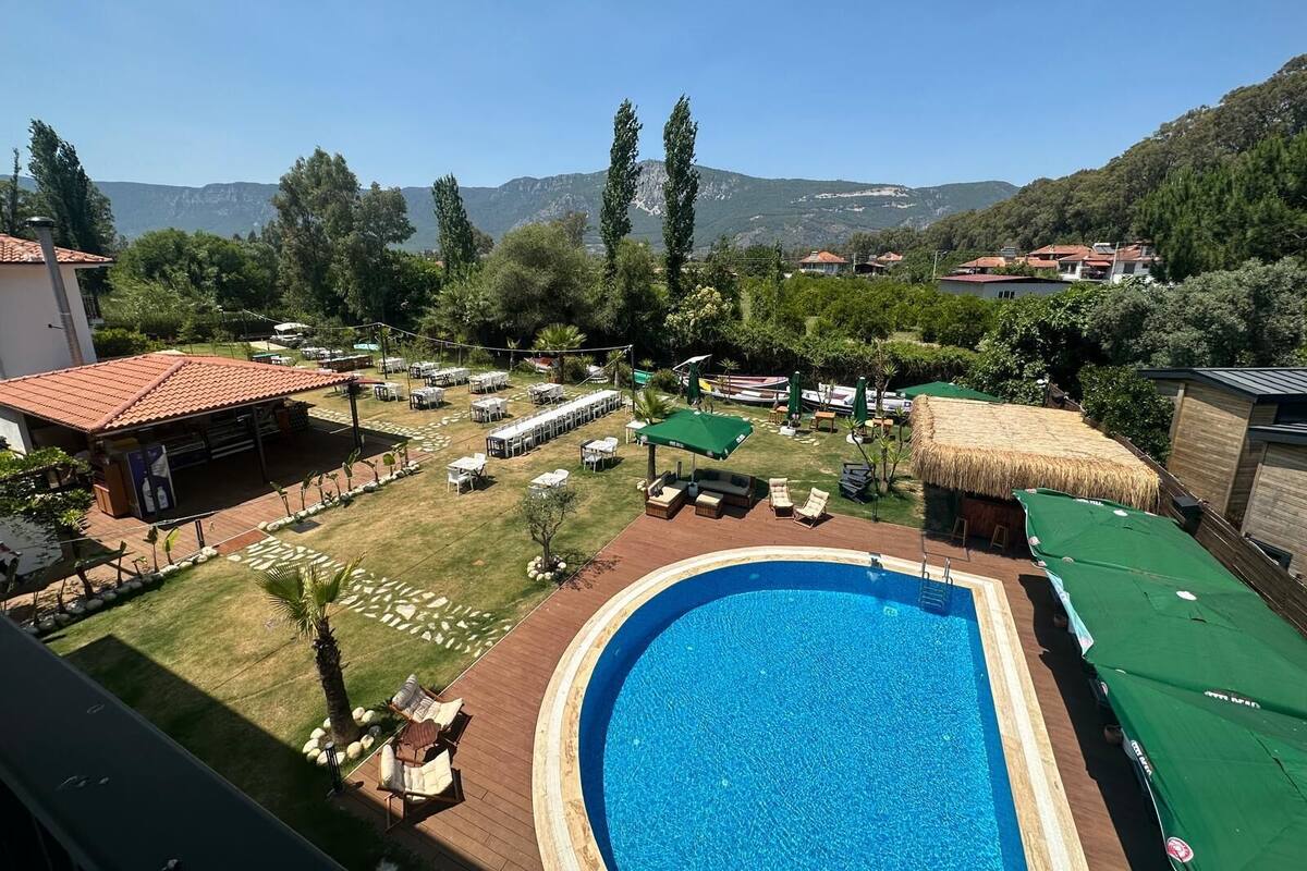 A pool area with a clear view of the surrounding landscape, including hills and trees.
