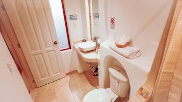 A bathroom with a toilet, sink, and towel rack.